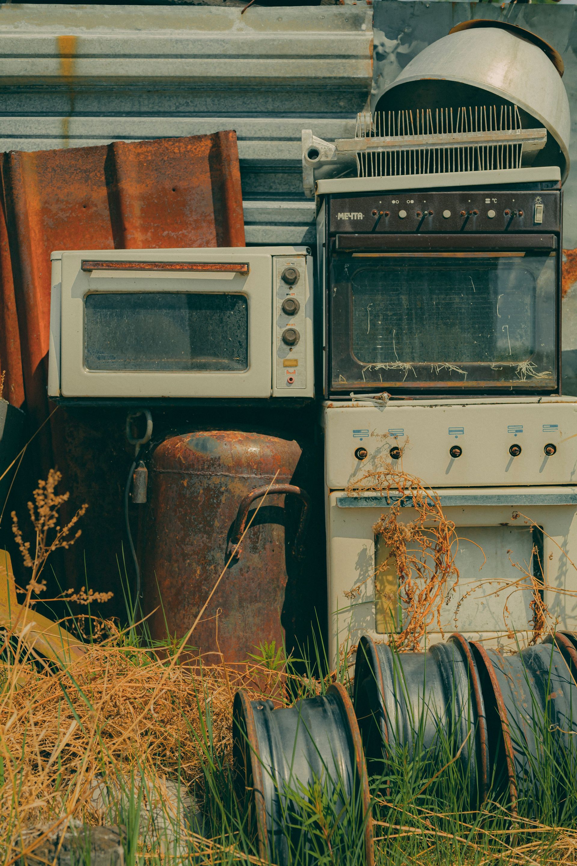 Old appliances and other items sit discarded